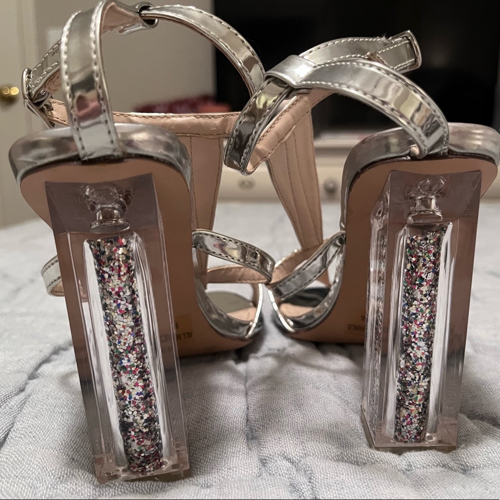 Very fun silver shoes with clear, glitter heels, size 6.5.